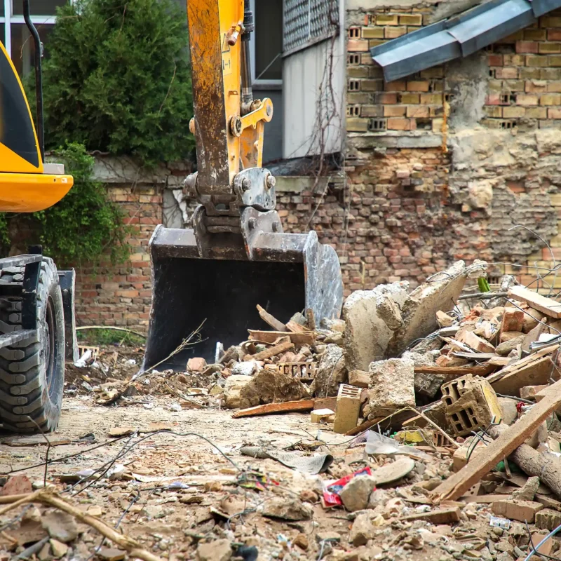 excavator-at-construction-site-with-pile-of-debris-2026-01-09-01-15-36-utc