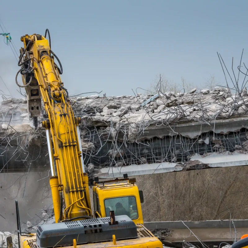 excavator-demolishing-a-concrete-structure-with-st-2026-01-11-09-20-18-utc